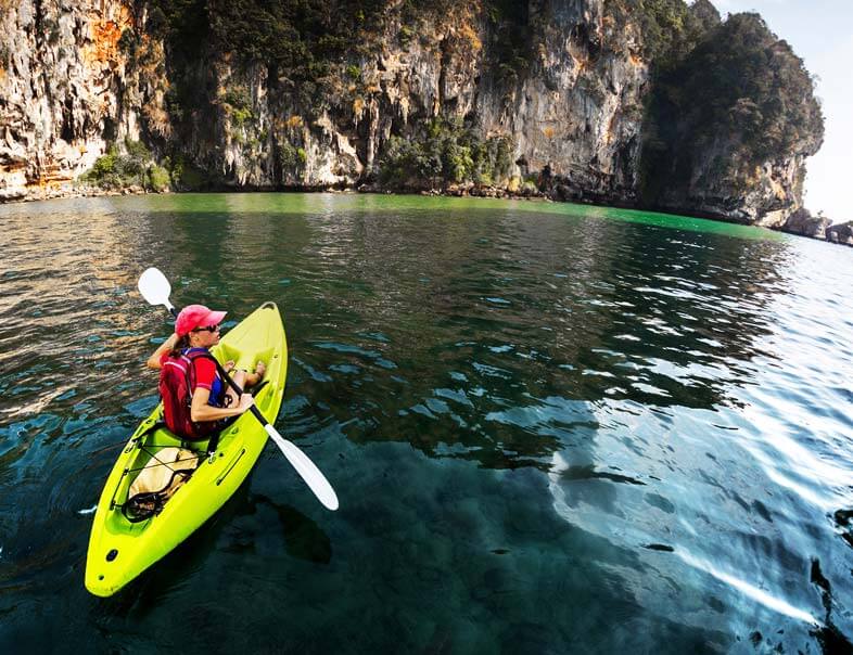 Kayaking in the ocean near rocks