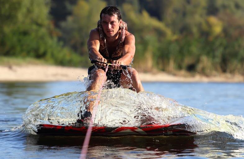 Wakeboarder in water with no wakeboard helmet